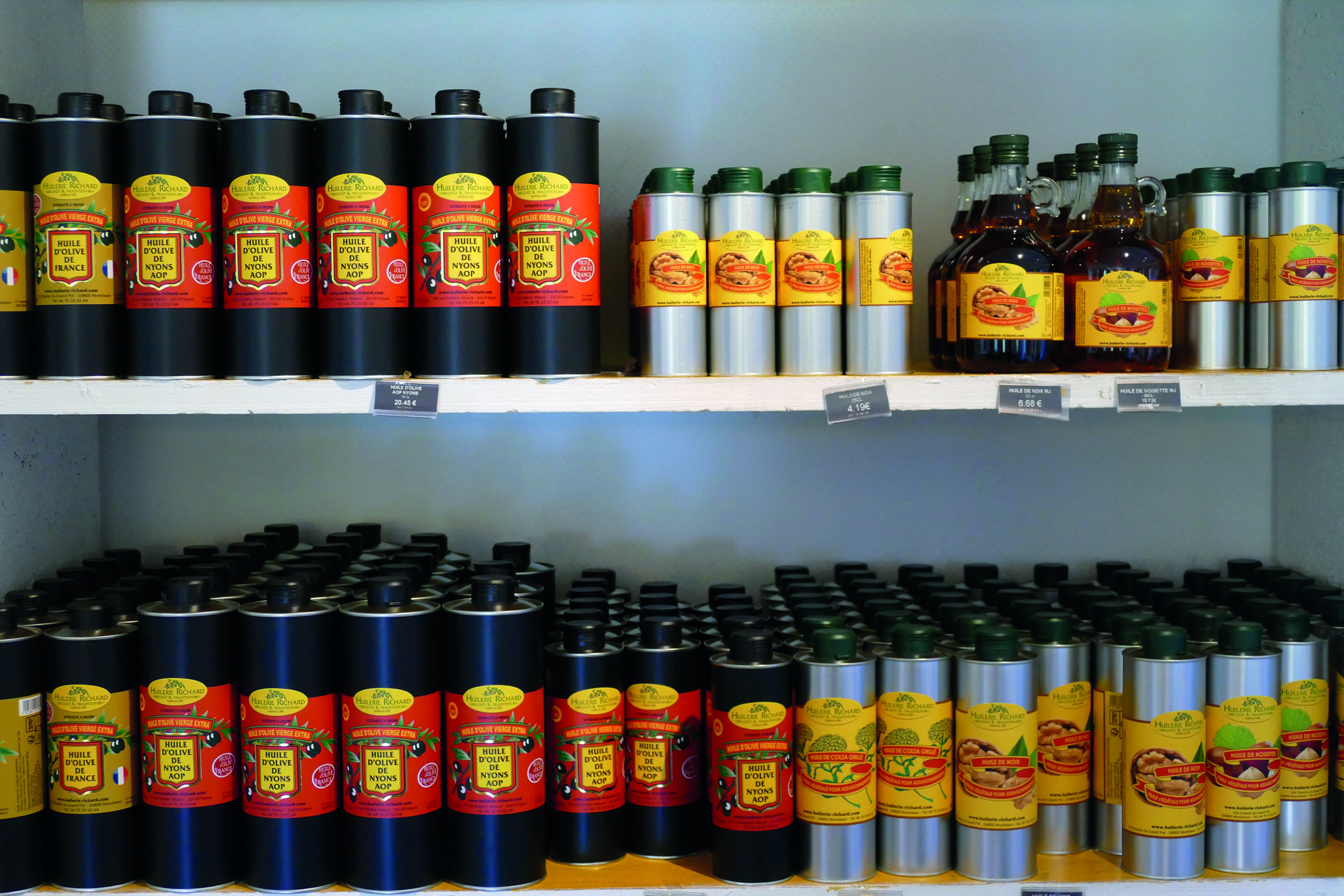 Shelves of olive and nut oils at Huilerie Richard