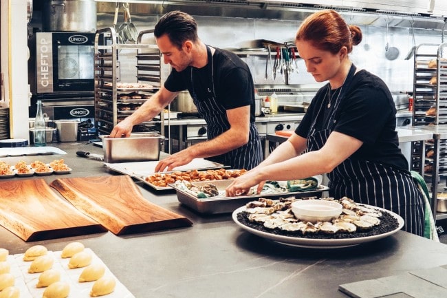 Gender balance starting to change in professional kitchens, photo of a man and woman working together in a restaurant kitchen