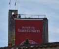 tower with large red draping that reads 'Jurade de Saint Emilion'