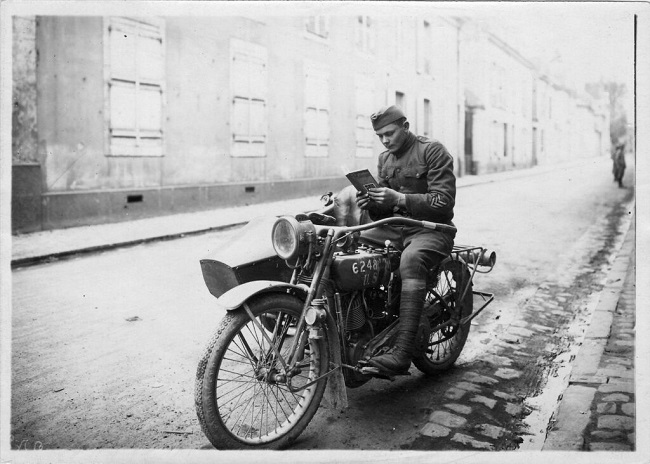 black and white photo of an American soldier on a motorbike
