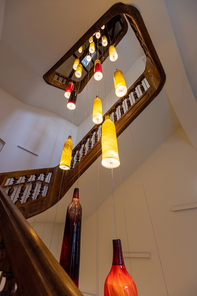 stairwell installation featuring bottled lights